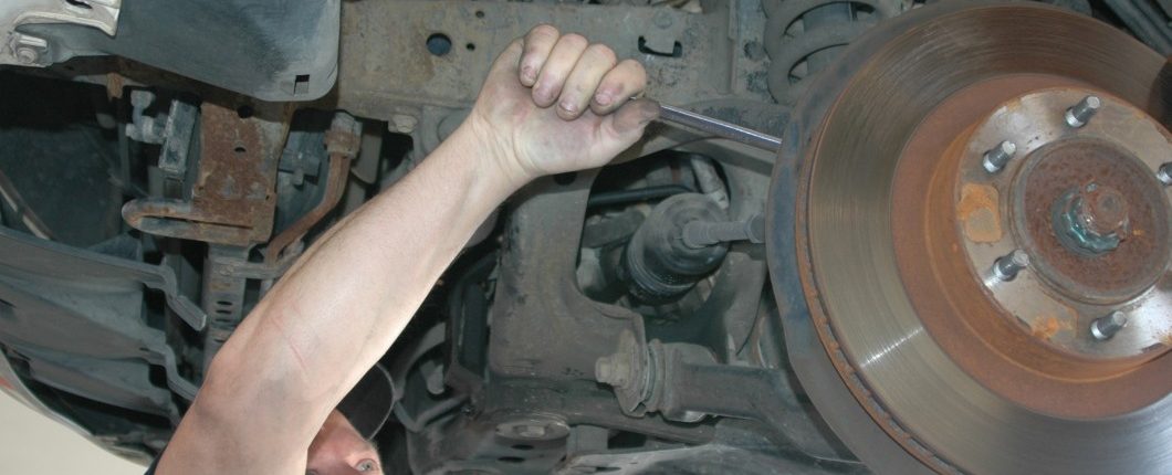 Image of a mechanic repair the front end suspension on a vehicle at Ross Tire & Service in Lafayette, LA
